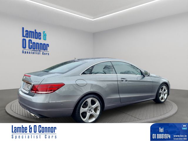 Image for 2015 Mercedes-Benz E Class E 220 AUTO COUPE * PALLADIUM SILVER METALIC / RED LEATHER * ACTIVE PARK ASSIST * HEATED SEATS * LOW MILEAGE WITH A DOCUMENTED SERVICE RECORD * BEST AVAILABLE * 