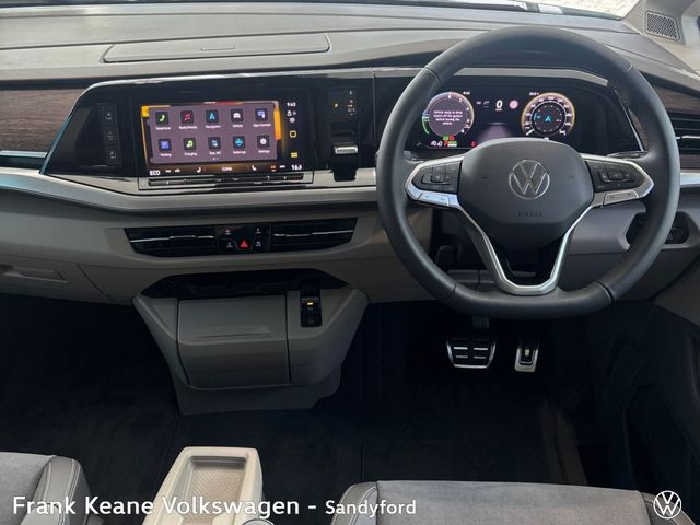 Image for 2025 Volkswagen Multivan T7 STYLE PHEV 240HP A6A LOH *DEMO MODEL* *19" HALMSTED ALLOYS* *FIXED PANAROMIC SUNROOF* *APPLE CARPLAY/ANDROID AUTO* *REAR VIEW CAMERA* *FRONT AND REAR PARKING SENSORS*