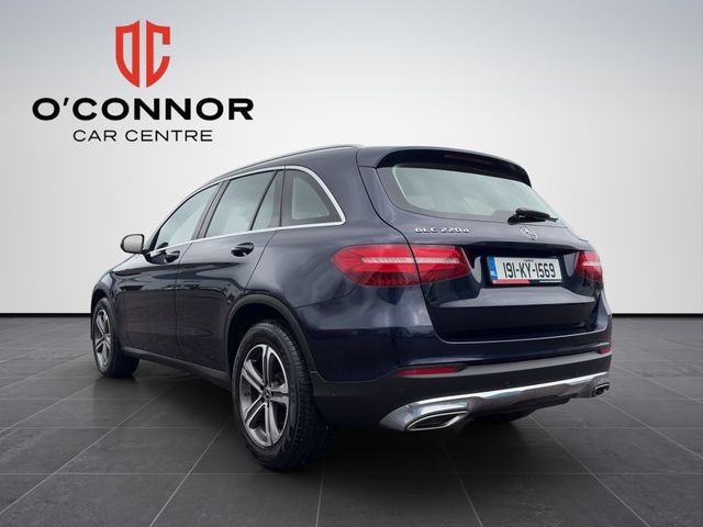 Image for 2019 Mercedes-Benz GLC Class Navy suit, cream interior — dressed better than most weddings.