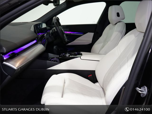 Image for 2025 BMW 5 Series *PANORAMIC SUNROOF, TECH PACK AND 20” ALLOYS* CARBON BLACK METALLIC WITH IVORY VEGANZA INTERIOR. 530e TOURING M-SPORT
