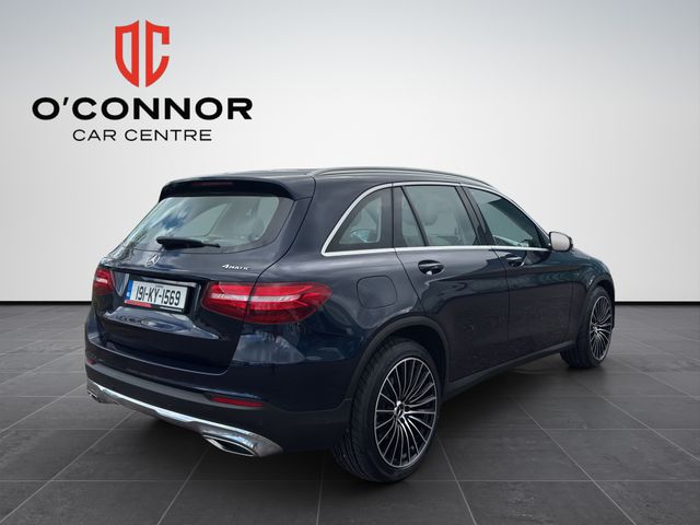 Image for 2019 Mercedes-Benz GLC Class Navy suit, cream interior — dressed better than most weddings.